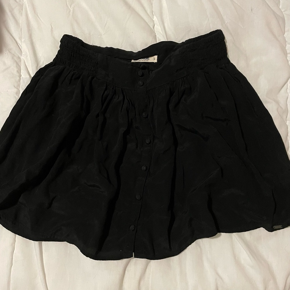 Garage high waisted black mini skirt with pockets.